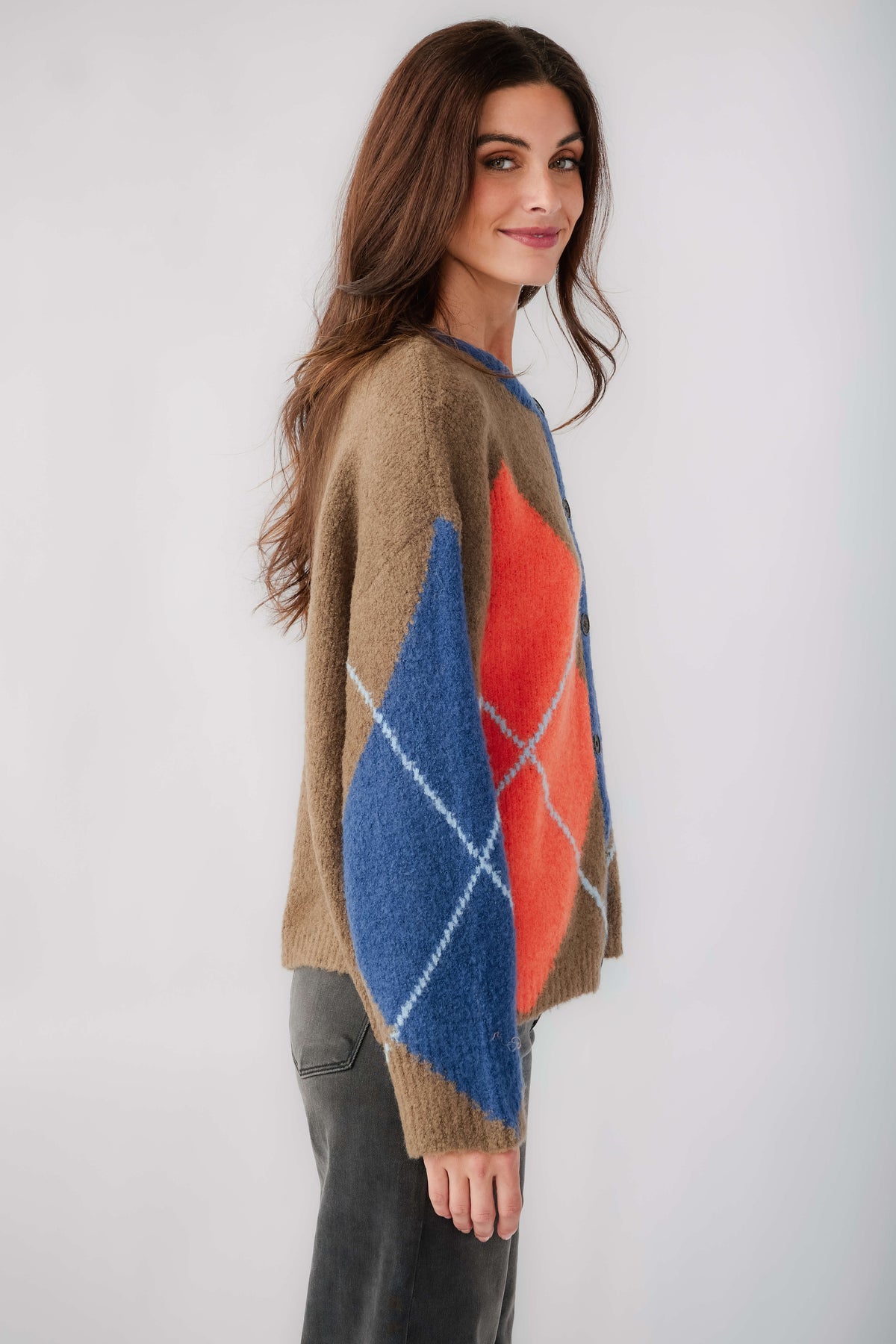 Kaki argyle cardigan, side view with button front and blue and orange diamond design.