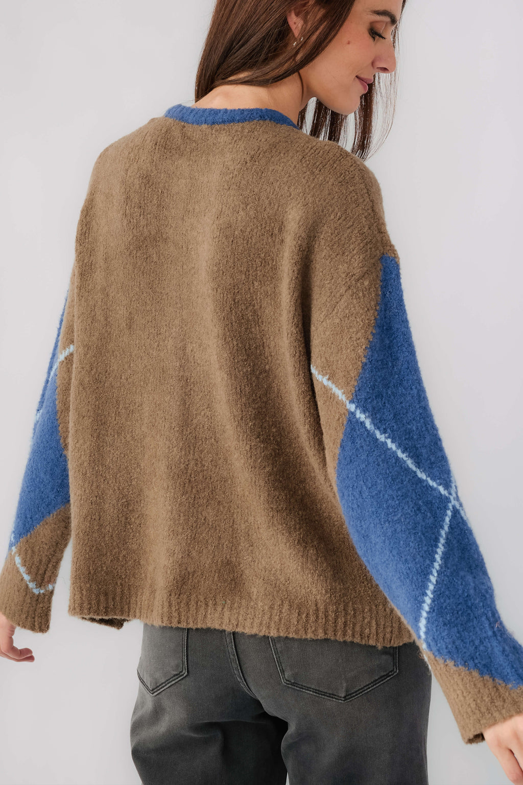 Kaki back of argyle cardigan with blue and orange diamond panels and button placket.