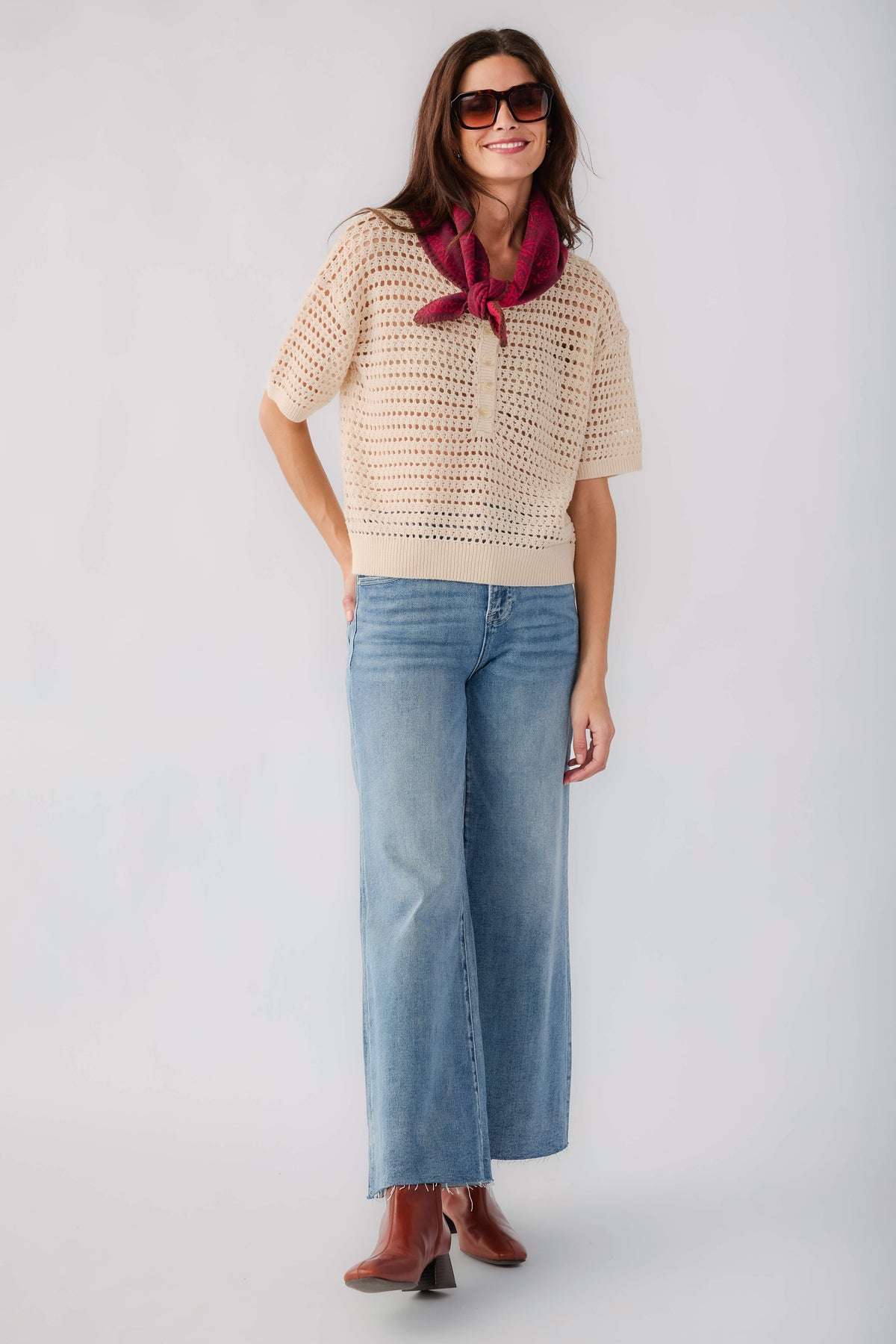 Cream open-knit polo sweater with short sleeves and button placket, full-body view