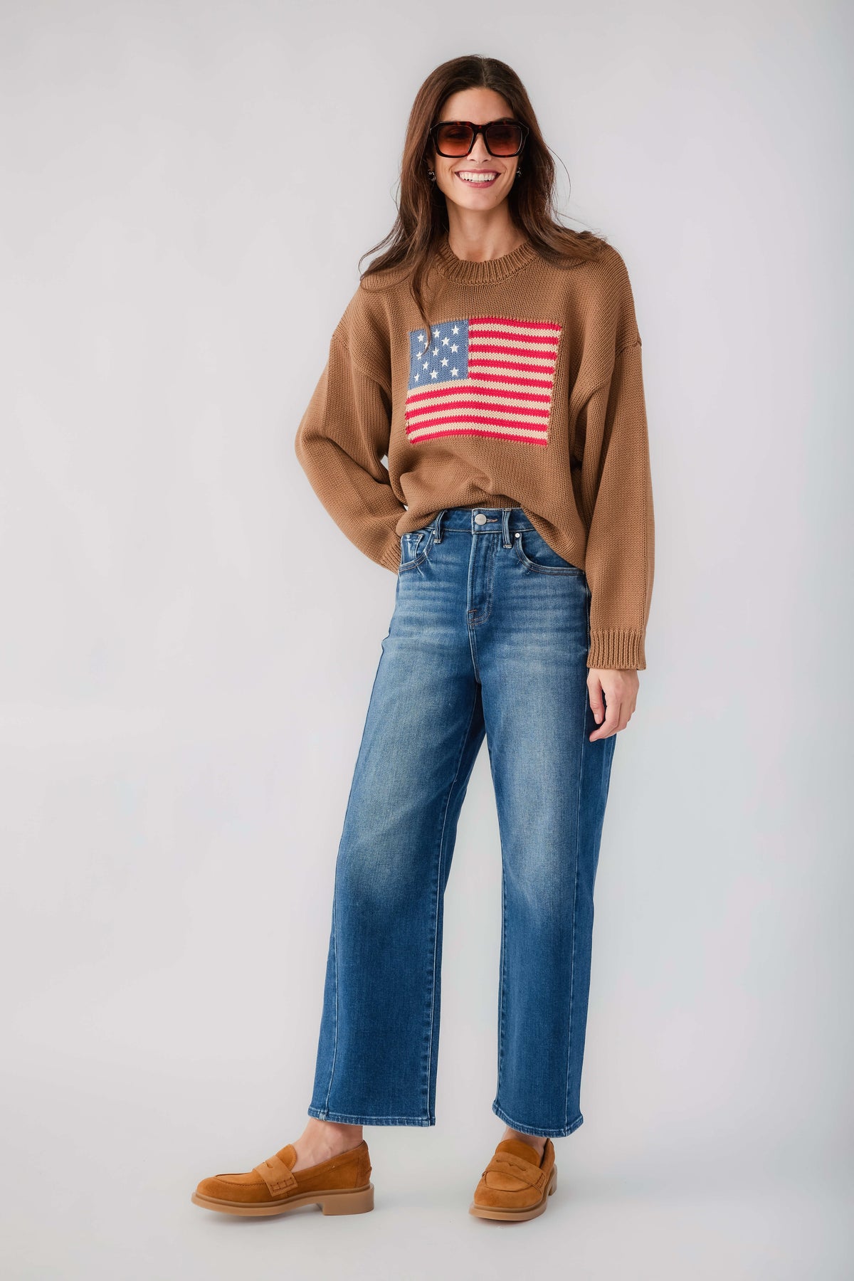 Olive brown crewneck sweater with American flag graphic and ribbed knit cuffs