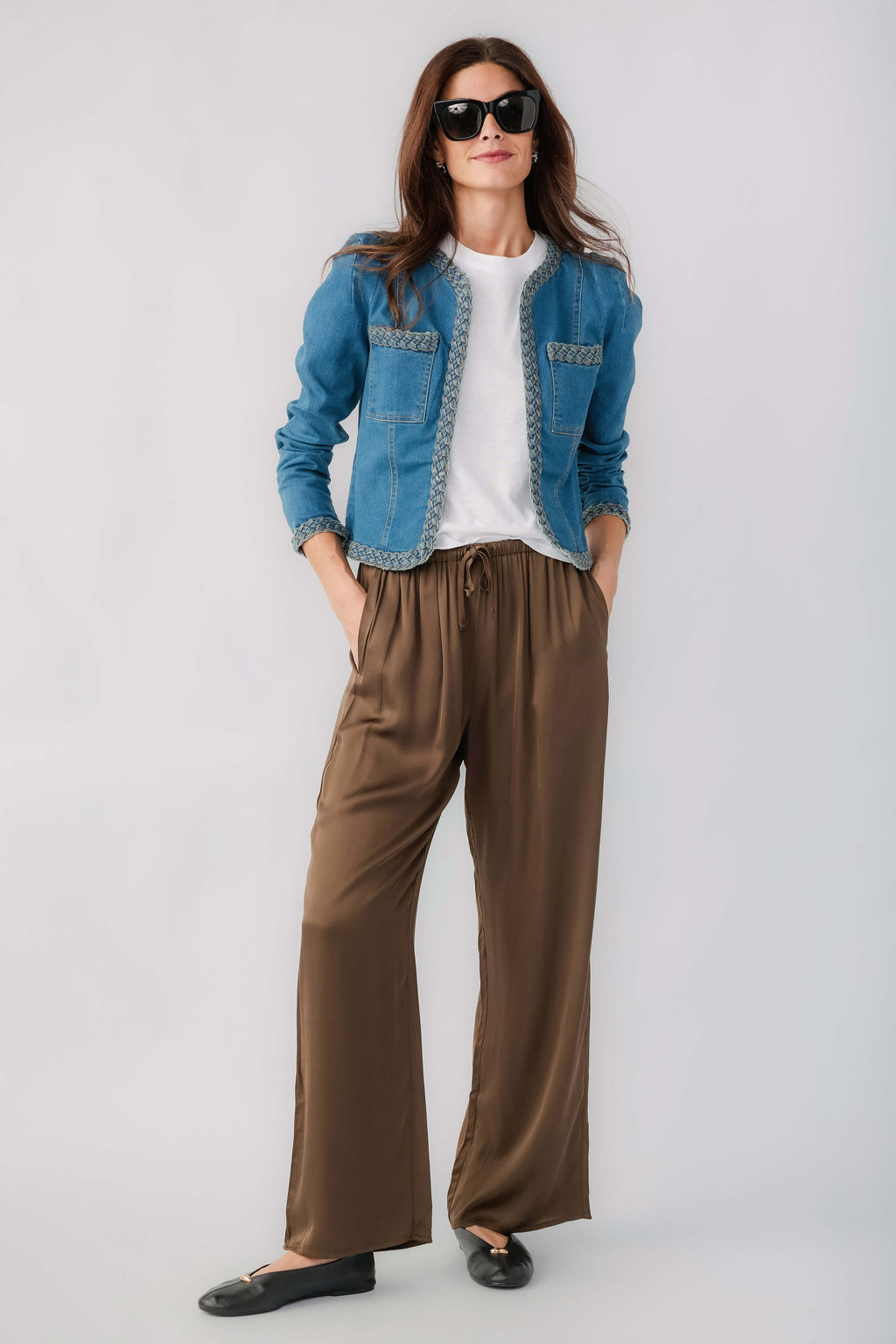 Medium wash denim jacket with braided trim and front patch pockets