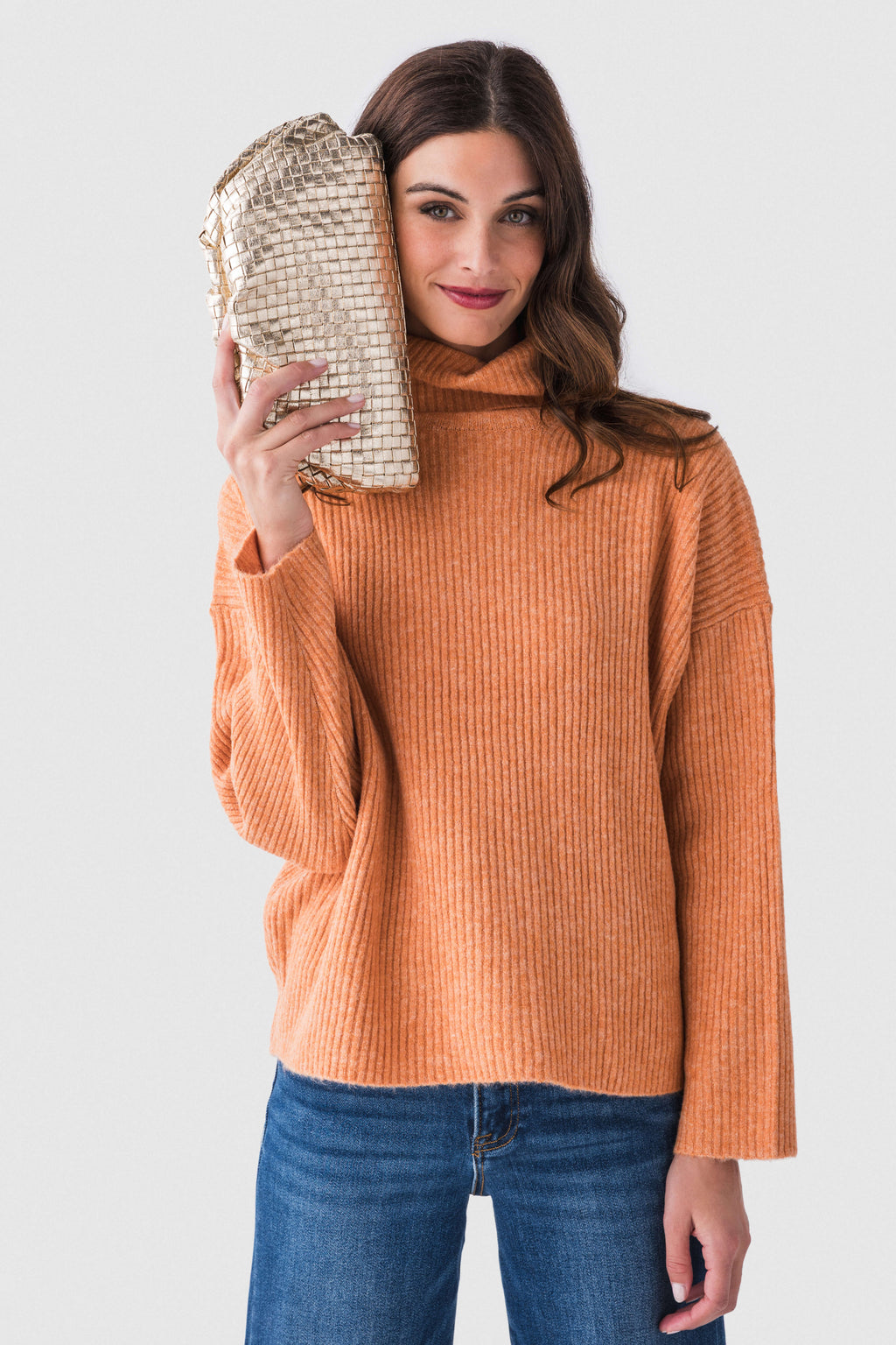 Gold woven frame clutch held up, metallic weave with braided chain strap.