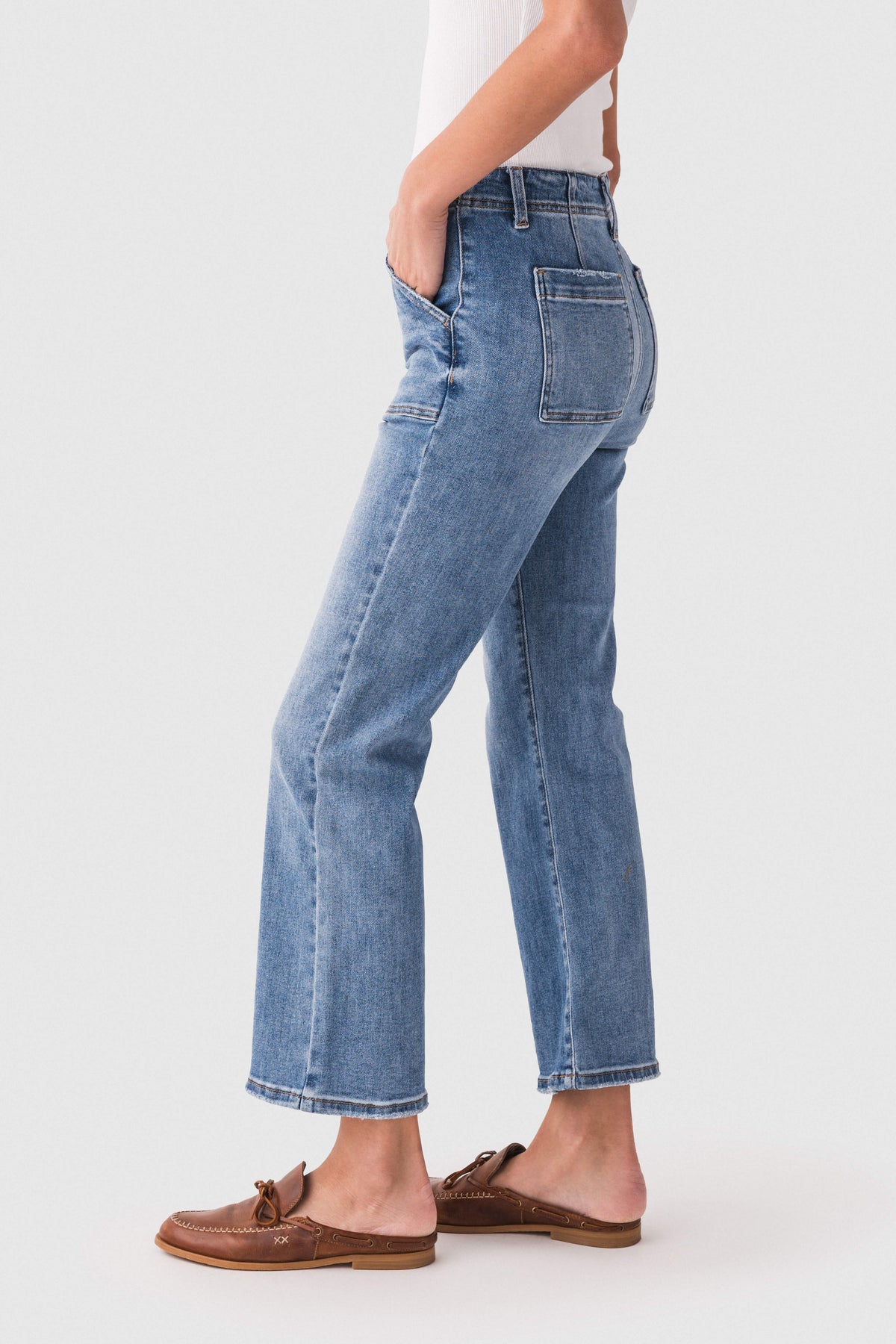 Medium blue ankle flare jeans shown from the side, five-pocket and belt-loop styling