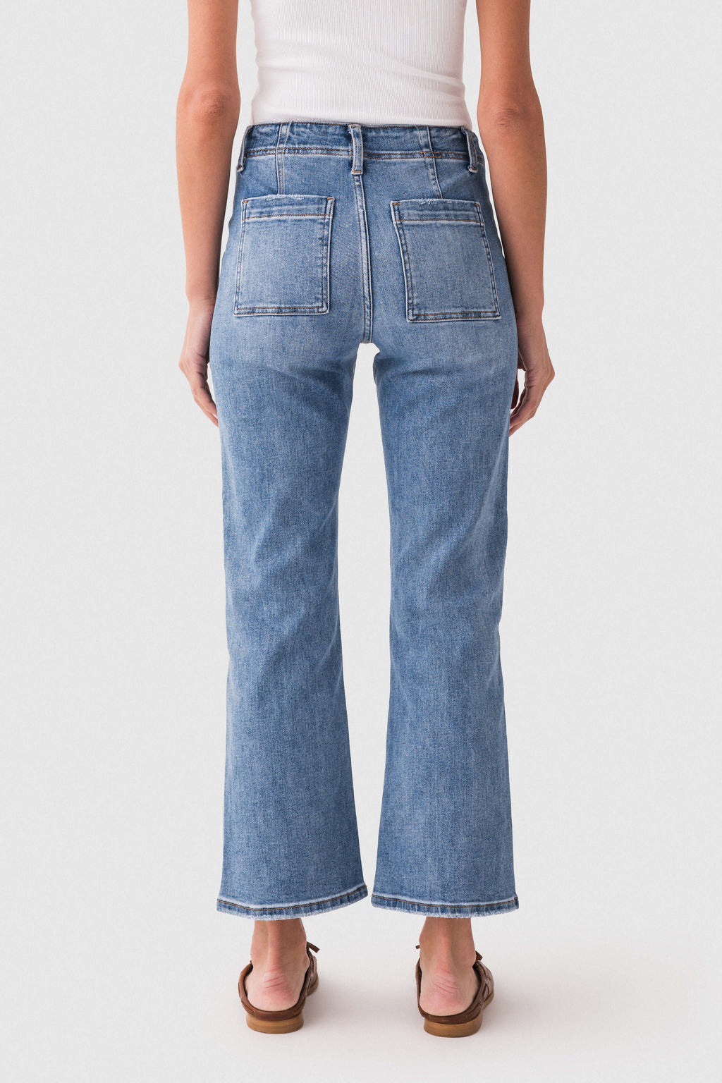 Blue ankle flare jeans back view with patch pockets and belt loops