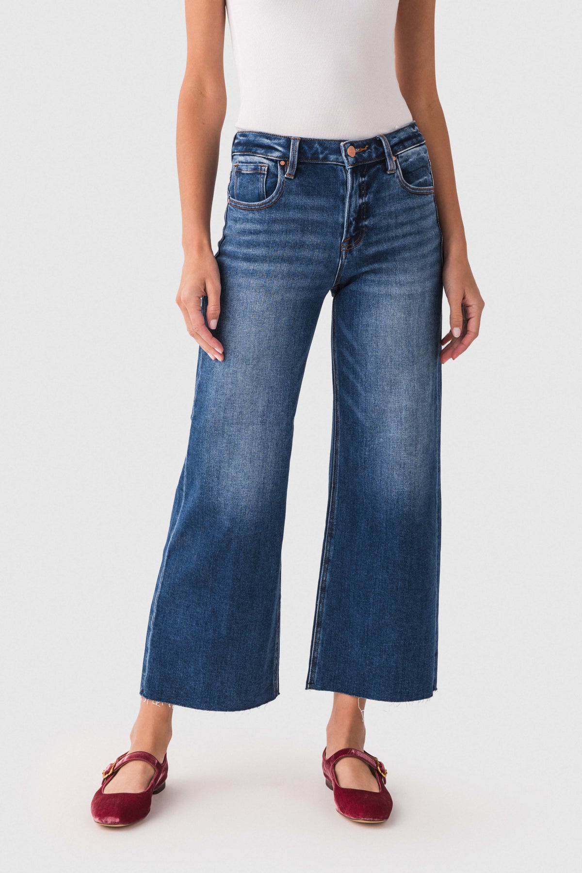 High-rise wide-leg dark wash denim jeans with front pockets and button fly