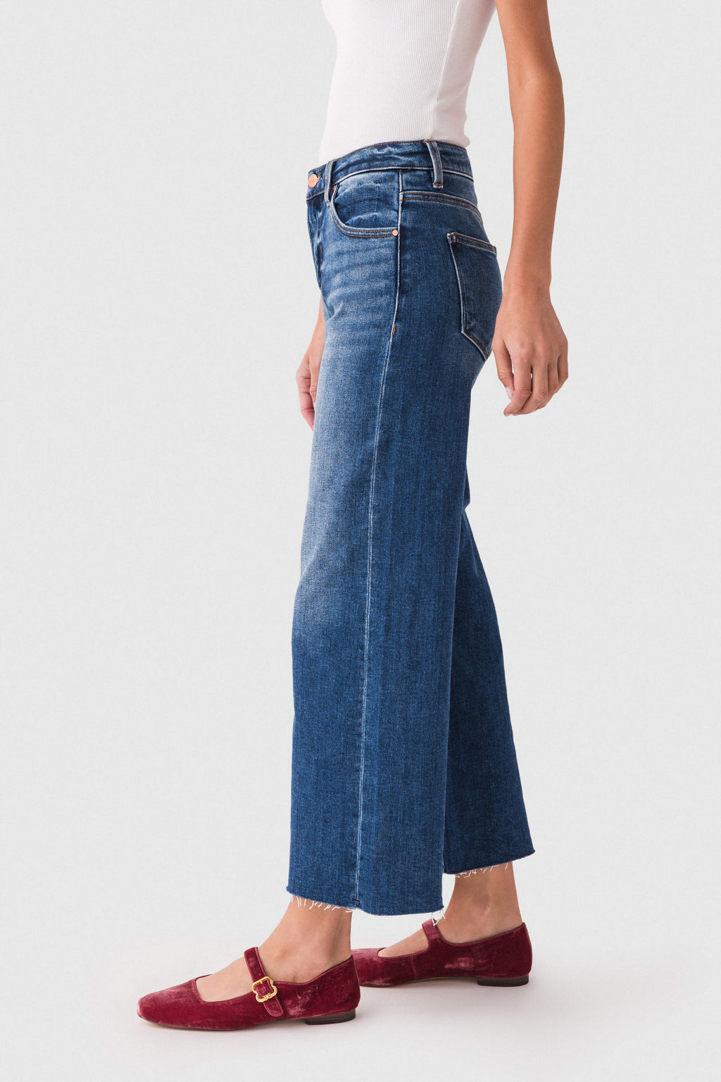 High-rise wide-leg dark wash denim jeans with front pockets and raw hem