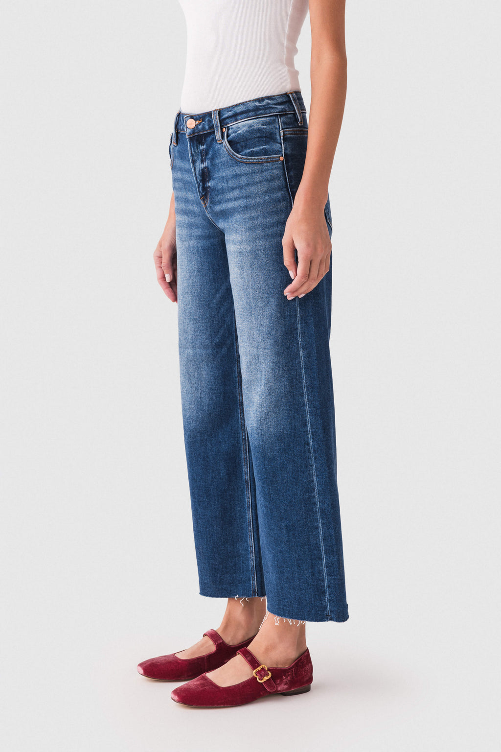 High-rise wide-leg dark wash denim jeans with belt loops and raw hem