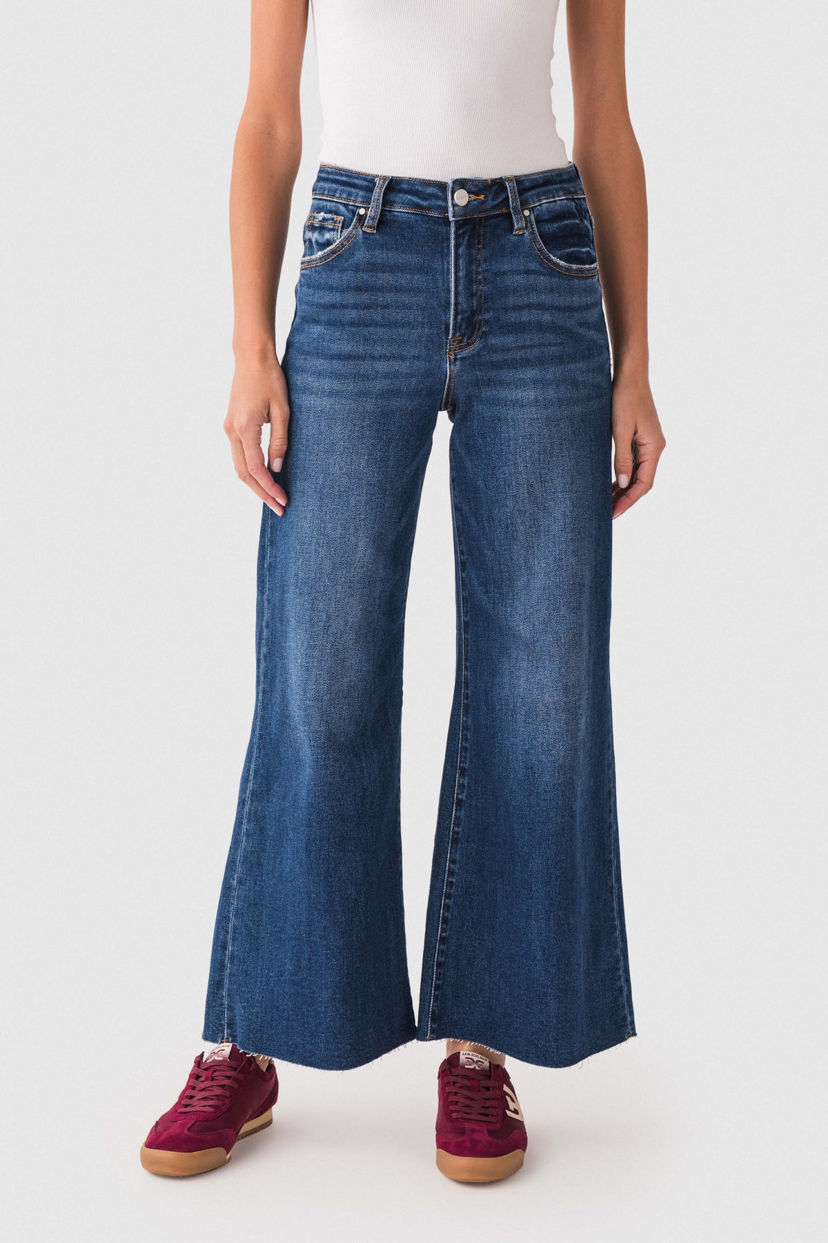 Front view of dark blue raw-hem palazzo jeans with belt loops and wide flare leg