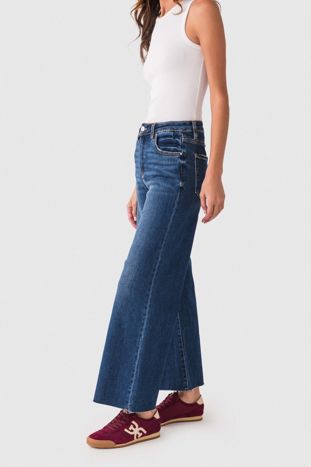 Dark blue denim raw-hem palazzo jeans with five-pocket styling and wide flare leg