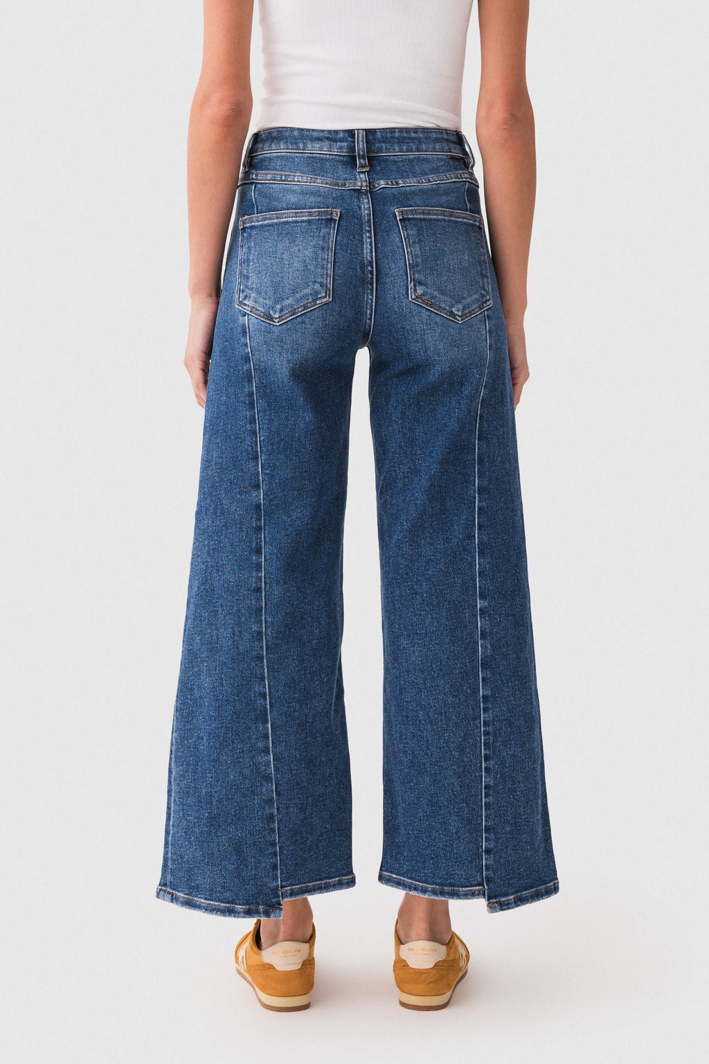 Dark blue high-rise jeans with front seam detail and wide barrel fit