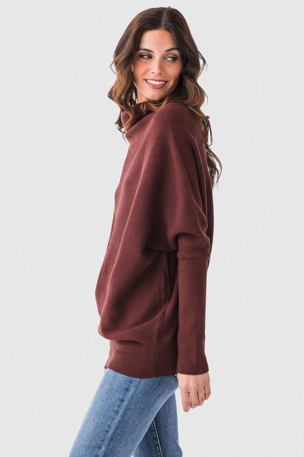 Burgundy dolman pullover sweater with slouch neck and long sleeves, side view.