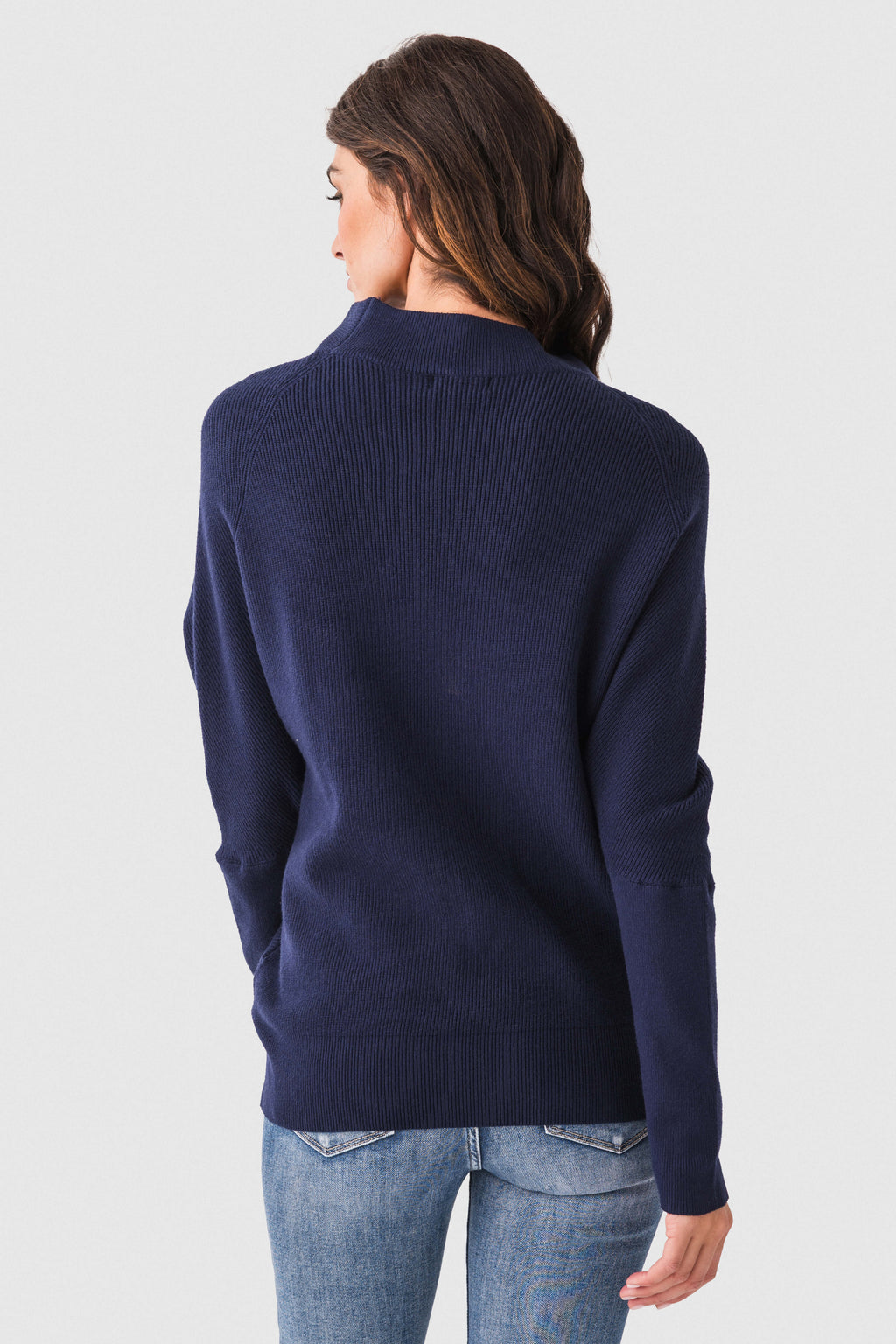 Navy dolman pullover sweater with slouch neck, ribbed cuffs, back view.