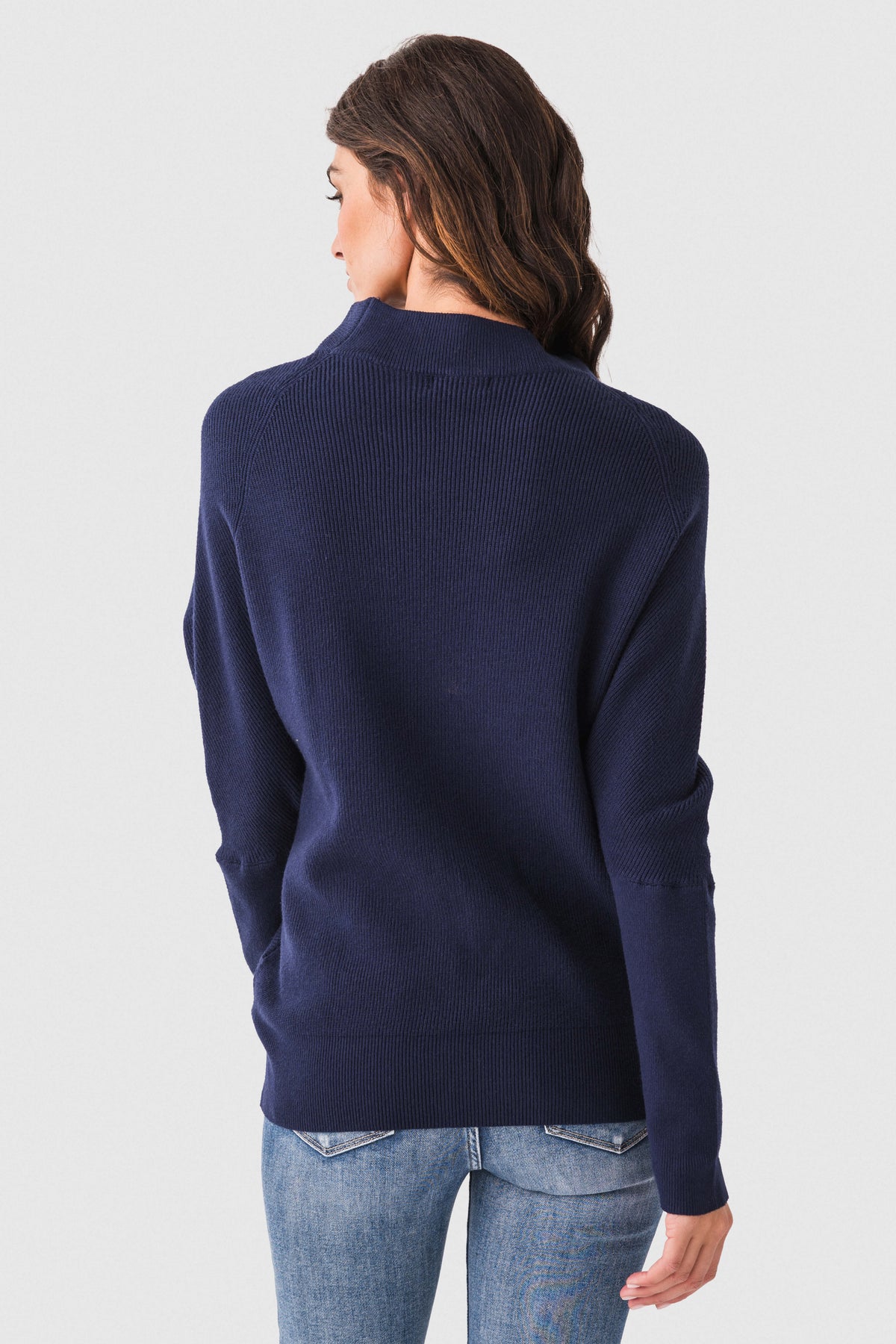 Navy dolman pullover sweater with slouch neck, ribbed cuffs, back view.