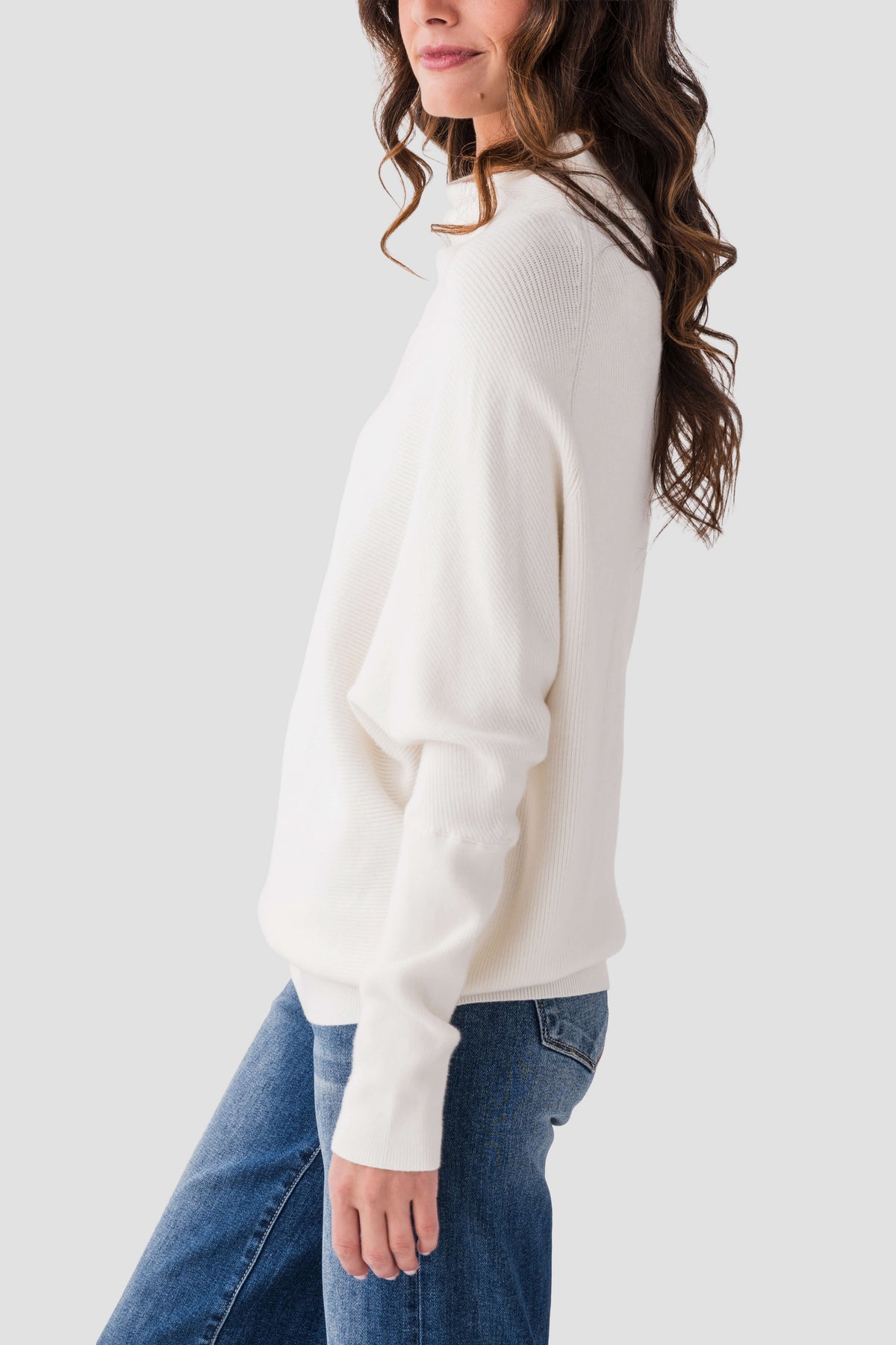 Cream slouch-neck dolman pullover sweater with long sleeves and relaxed drape