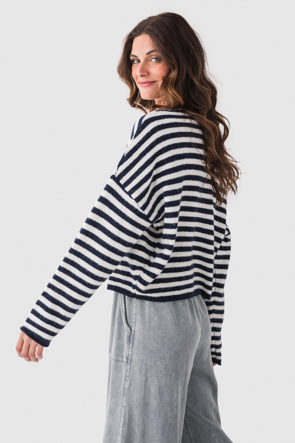 Navy-and-white striped button-front cardigan, long sleeves, side profile