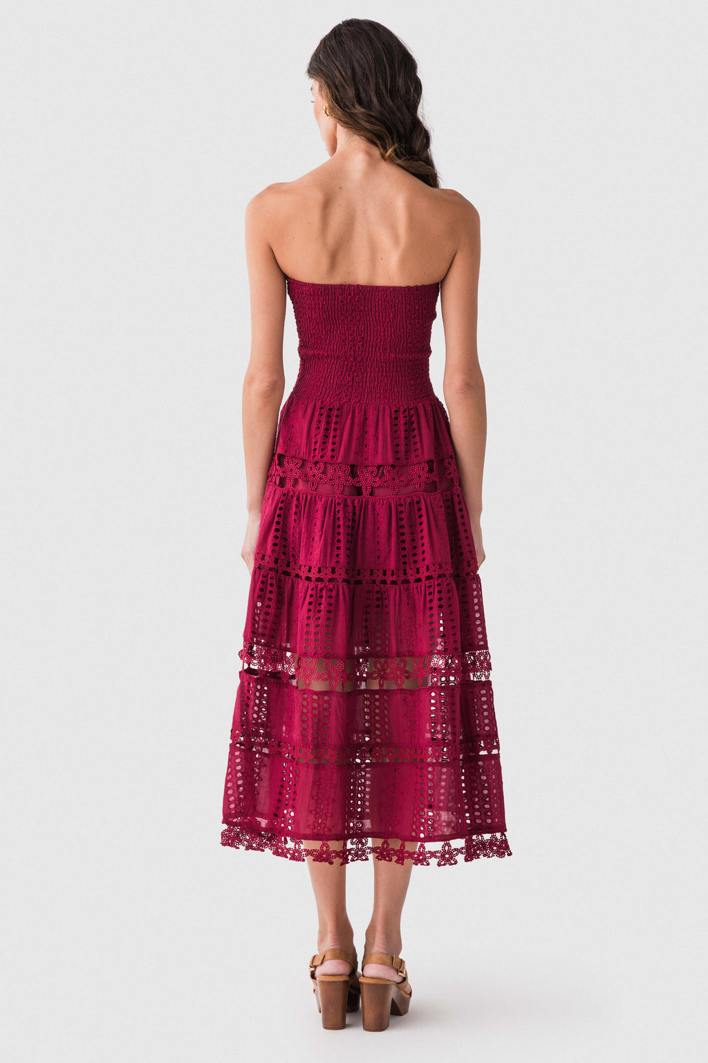 Back view of cherry burgundy eyelet lace tube dress with tiered skirt and smocked bodice
