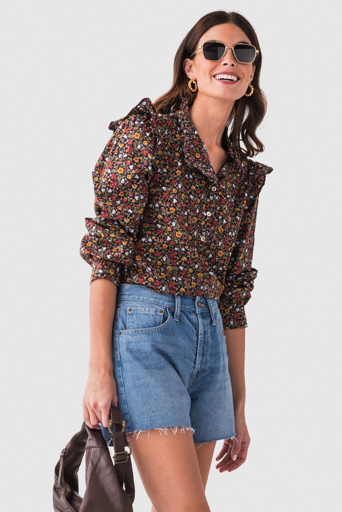 Black floral ruffle detail top with high neck, ruffled shoulders, and long sleeves