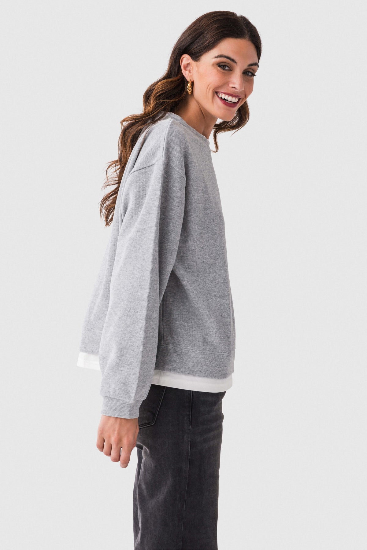 Heather gray crewneck pullover sweater in a side view with ribbed cuffs
