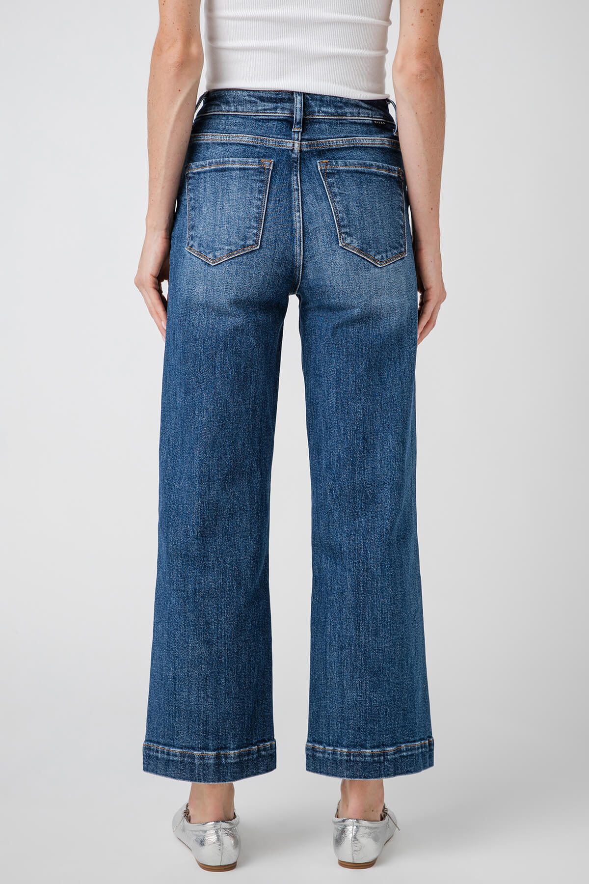 High-rise wide-leg ankle jeans in medium blue denim, back view with patch pockets