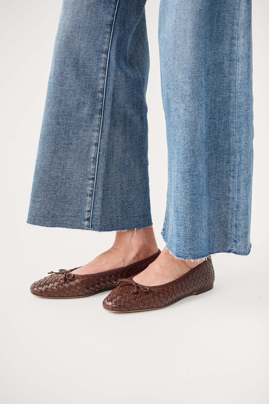 Brown woven ballet flats, side view showing textured upper and flat sole