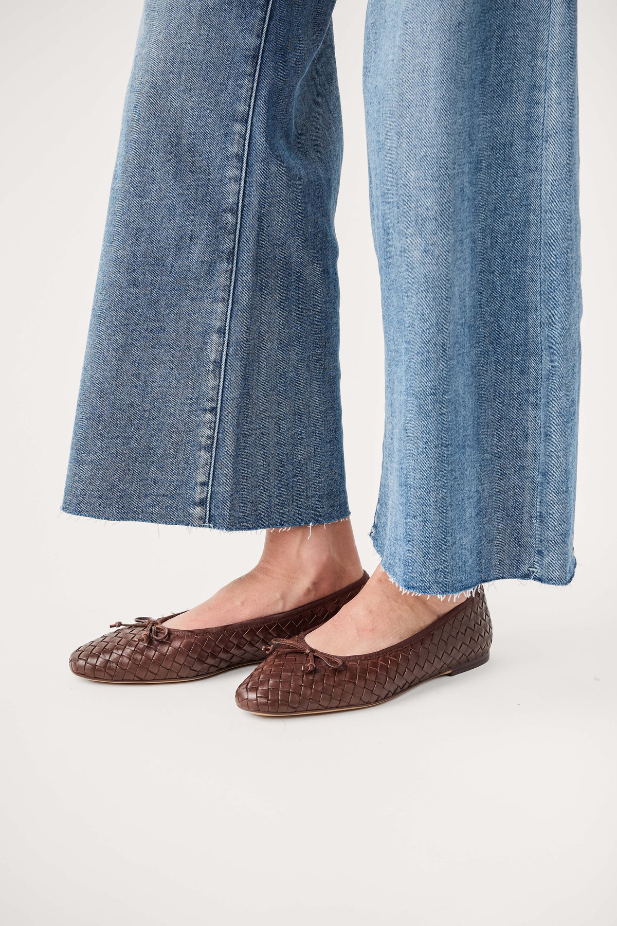 Brown woven ballet flats, side view showing textured upper and flat sole