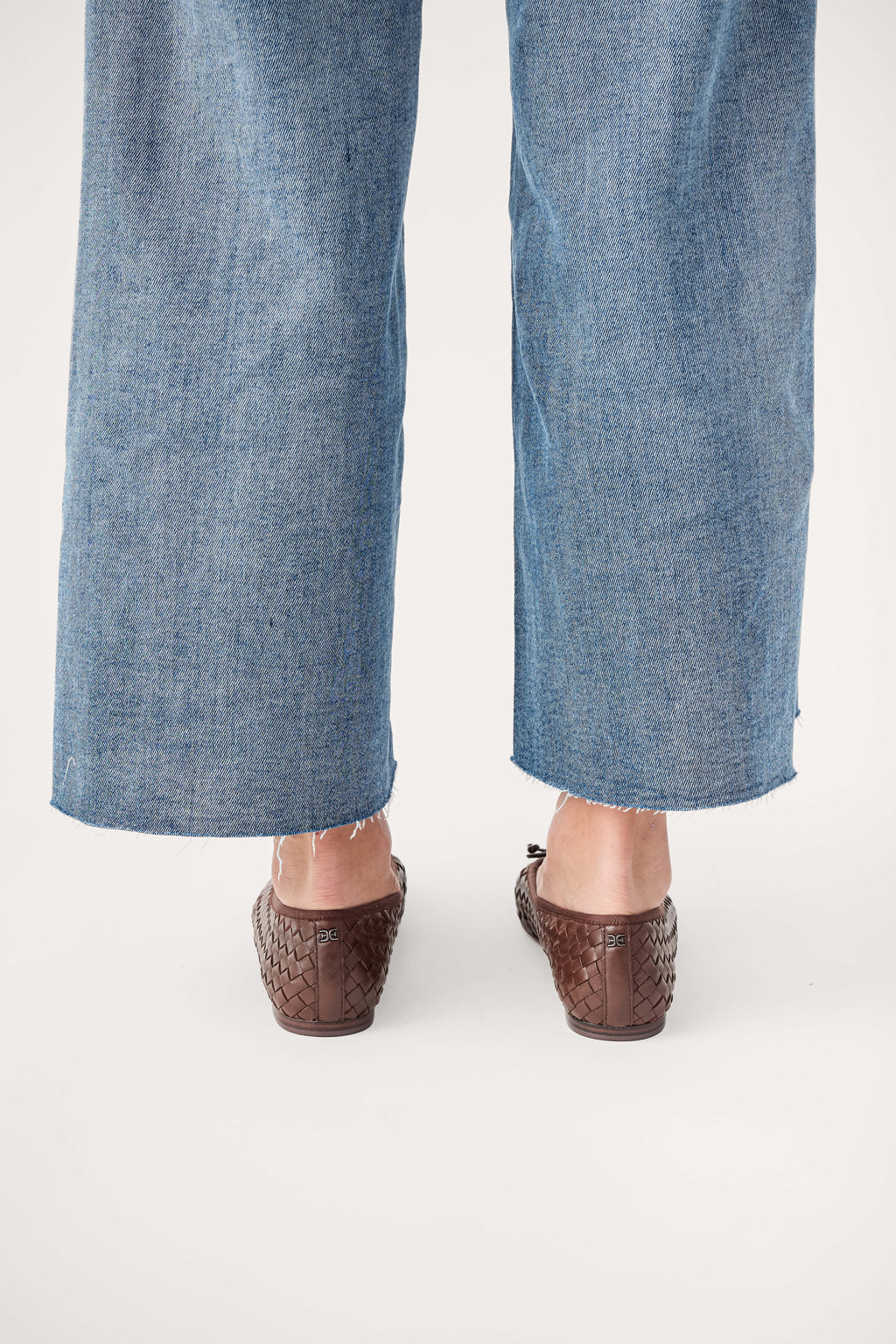 Brown woven ballet flats, rear view with low heel and woven texture