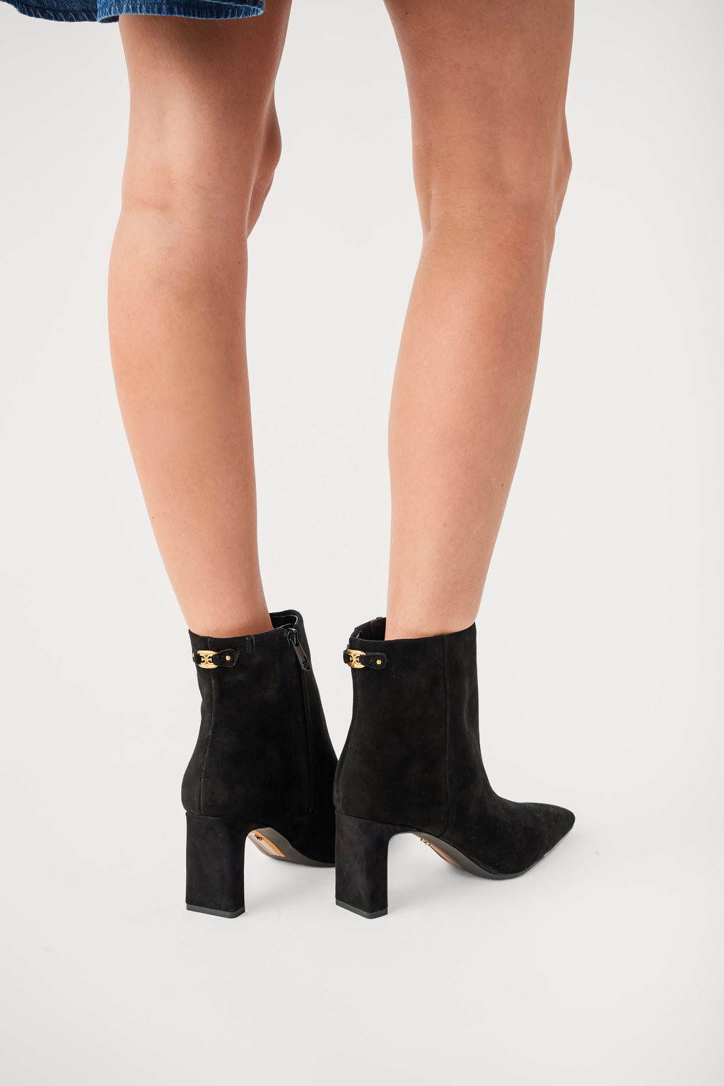 Black suede ankle boots with block heel and gold-toned buckle detail