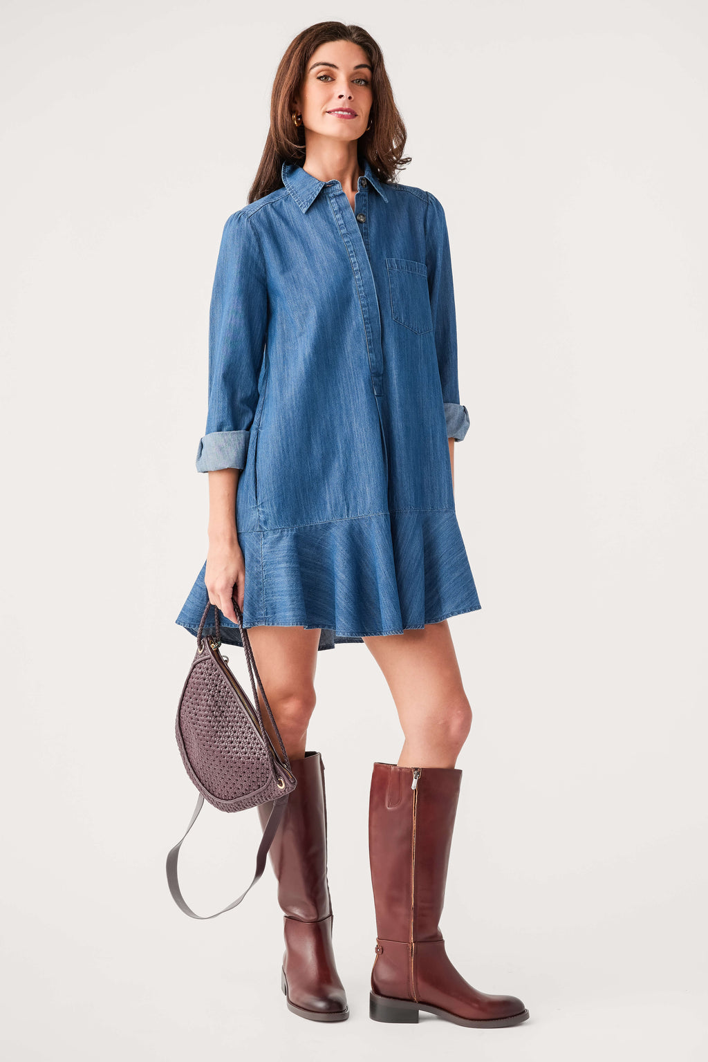 Blue denim shirt dress with pointed collar, button front, and tiered hem