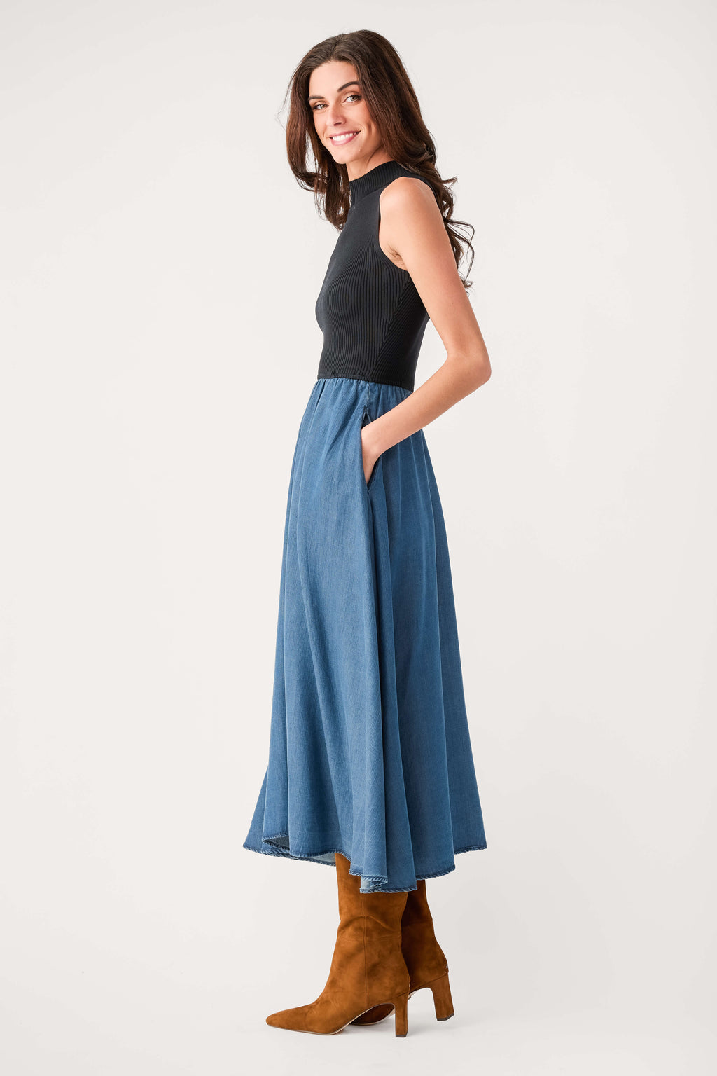 Side view sleeveless mock-neck denim maxi dress, black bodice and blue pleated skirt