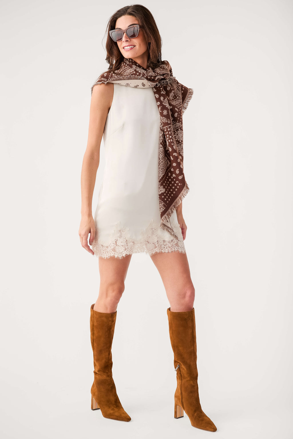 Brown bandana print scarf with light motifs and fringed trim draped on back