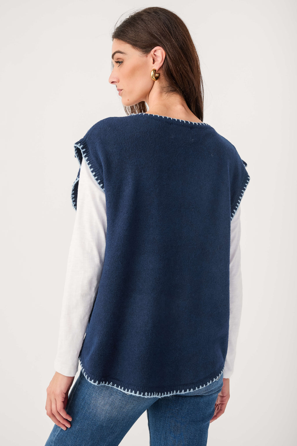 Back view of navy cap sleeve blanket-stitch sweater with contrast white sleeves