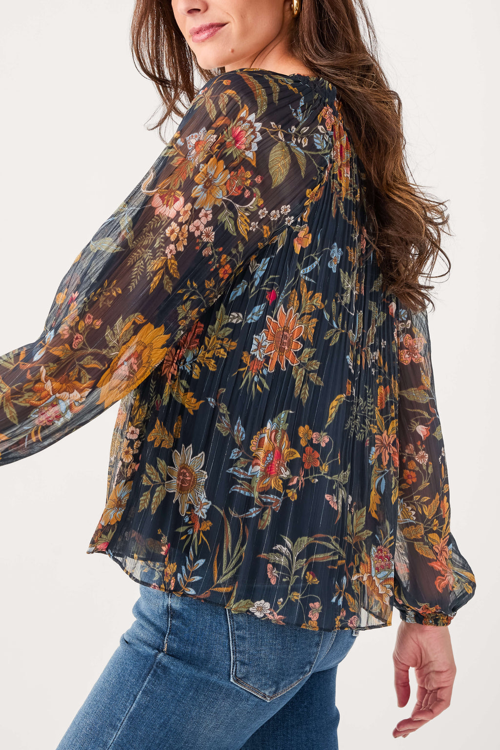 Navy floral pleated blouse with gathered neckline and flowing long sleeves