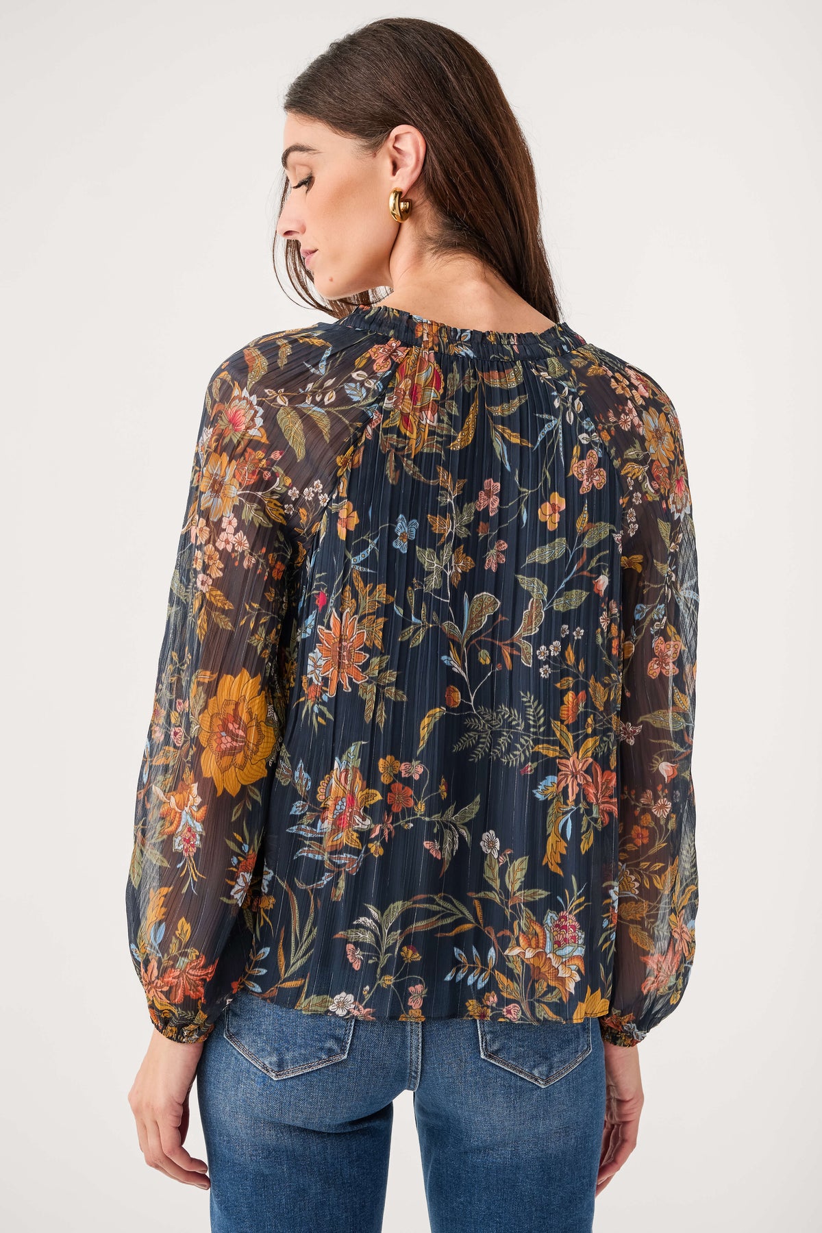 Back view: navy multi floral pleated blouse with rounded yoke and long sleeves