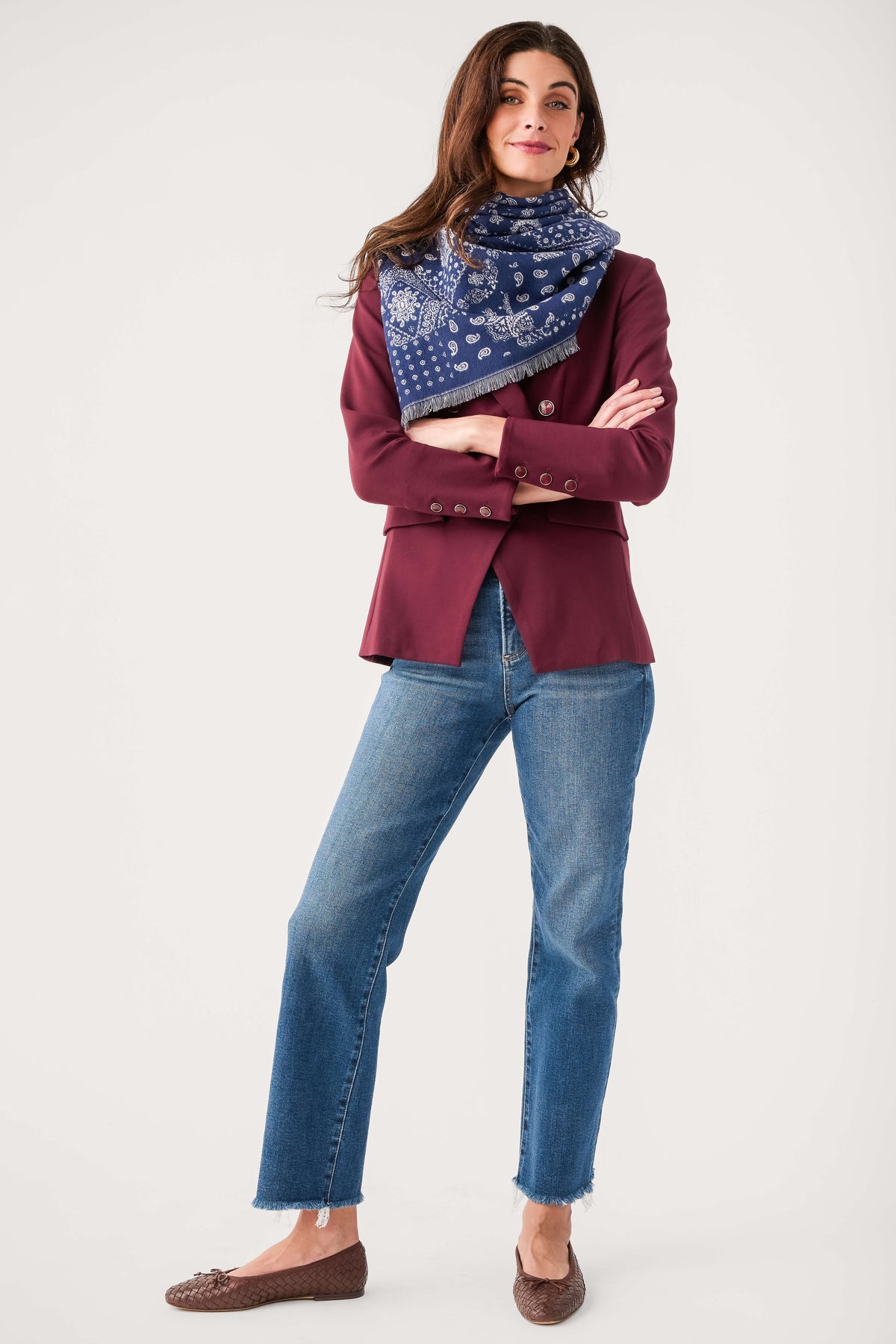 Navy bandana print scarf with fringe, draped around the neck over shoulders