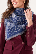 Navy bandana print scarf close-up with paisley-like pattern and fringed edges