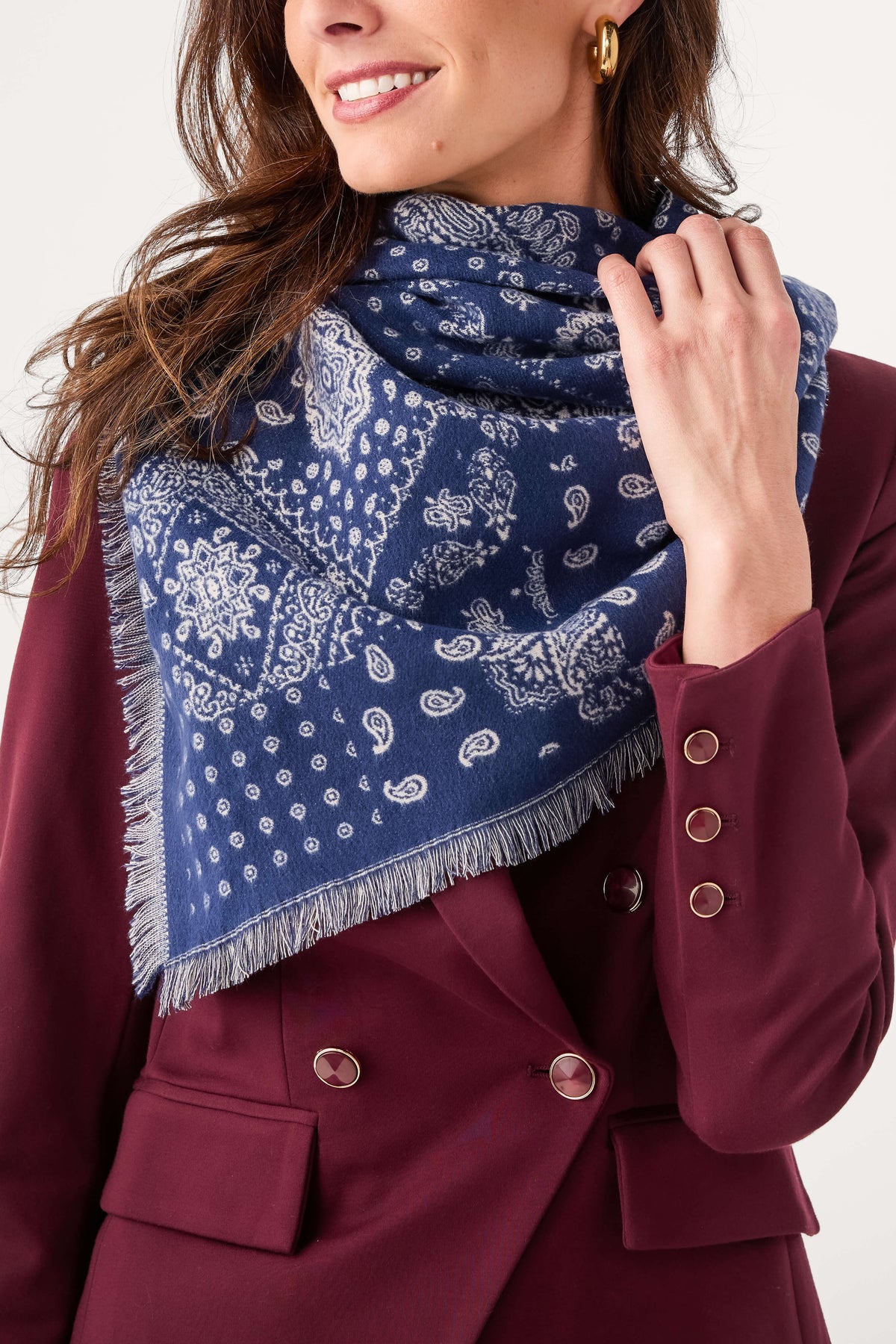 Navy bandana print scarf close-up with paisley-like pattern and fringed edges