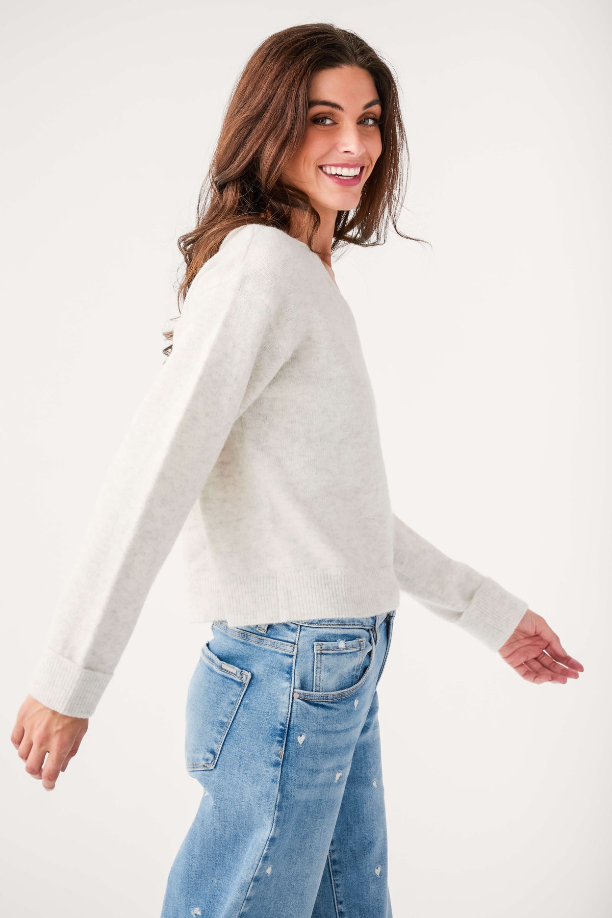 Light gray V-neck sweater, side view, long sleeves and knit texture