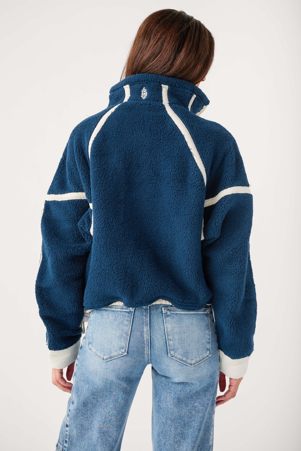 Back view: navy blue half-zip fleece pullover with white trim stripe panels