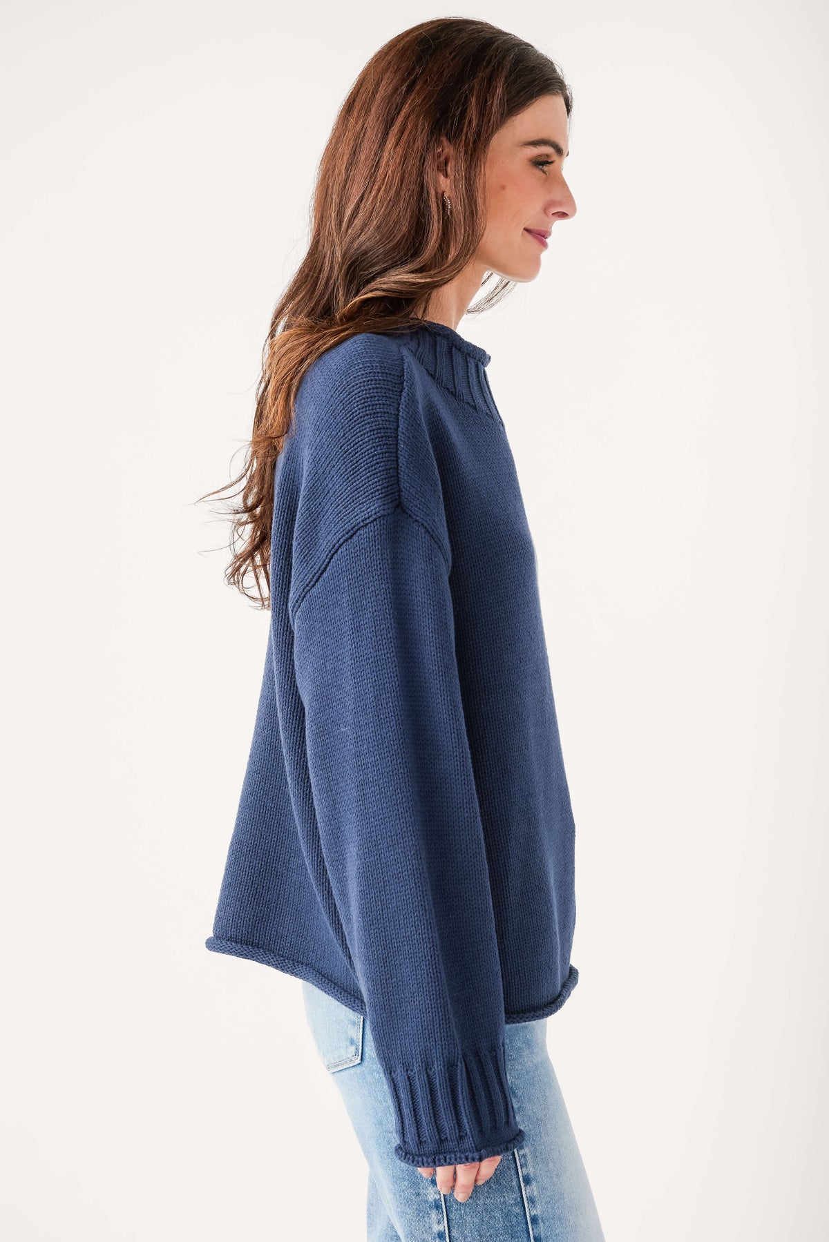 Navy mock neck knit sweater side view with ribbed cuffs and hem