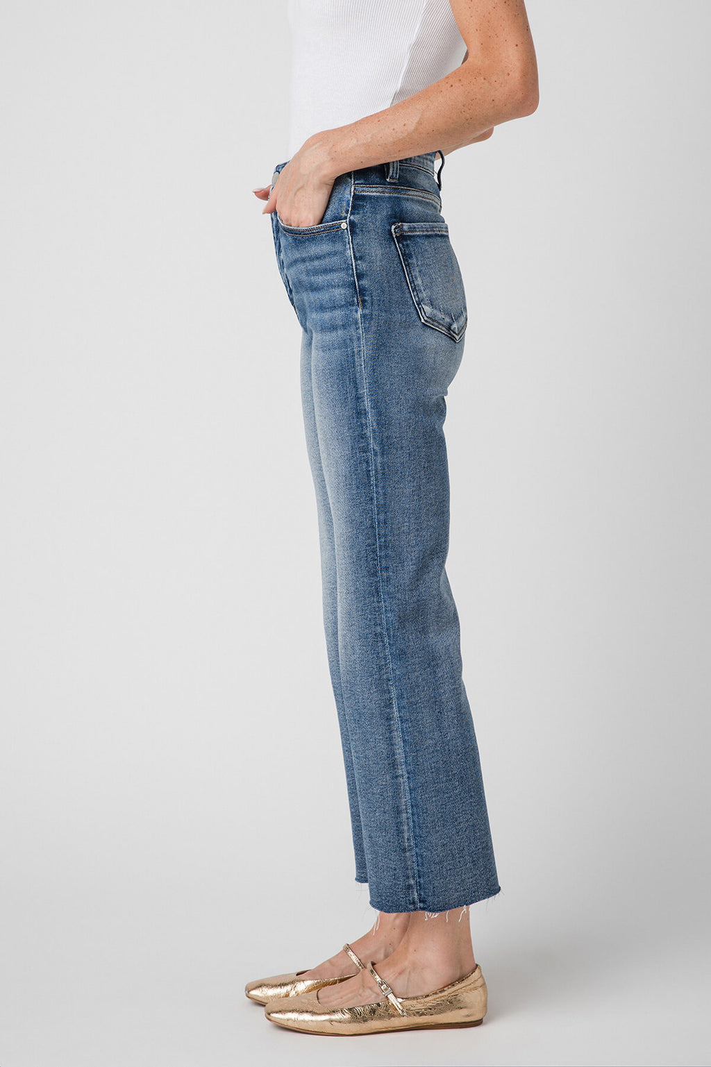 High-rise kick flare jeans in medium-wash blue, side view with straight waistband.