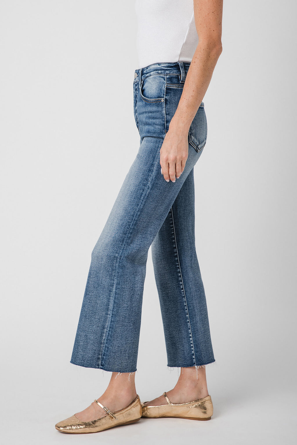 High-rise kick flare jeans in medium-wash blue, front angled view with belt loops.