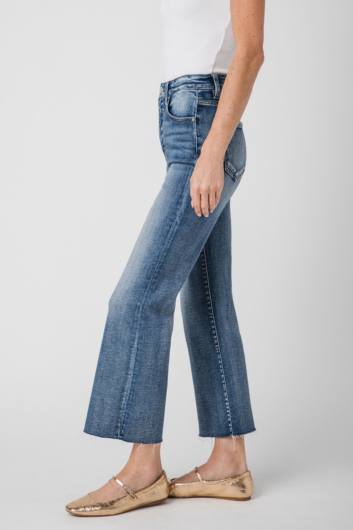 High-rise kick flare jeans in medium-wash blue, front angled view with belt loops.