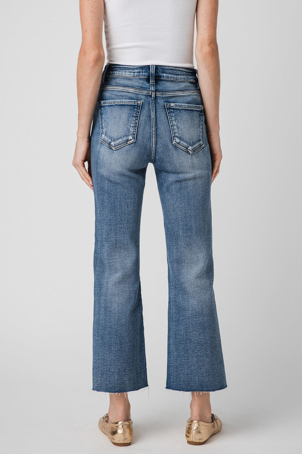 High-rise kick flare jeans in medium-wash blue, back view with double back pockets.