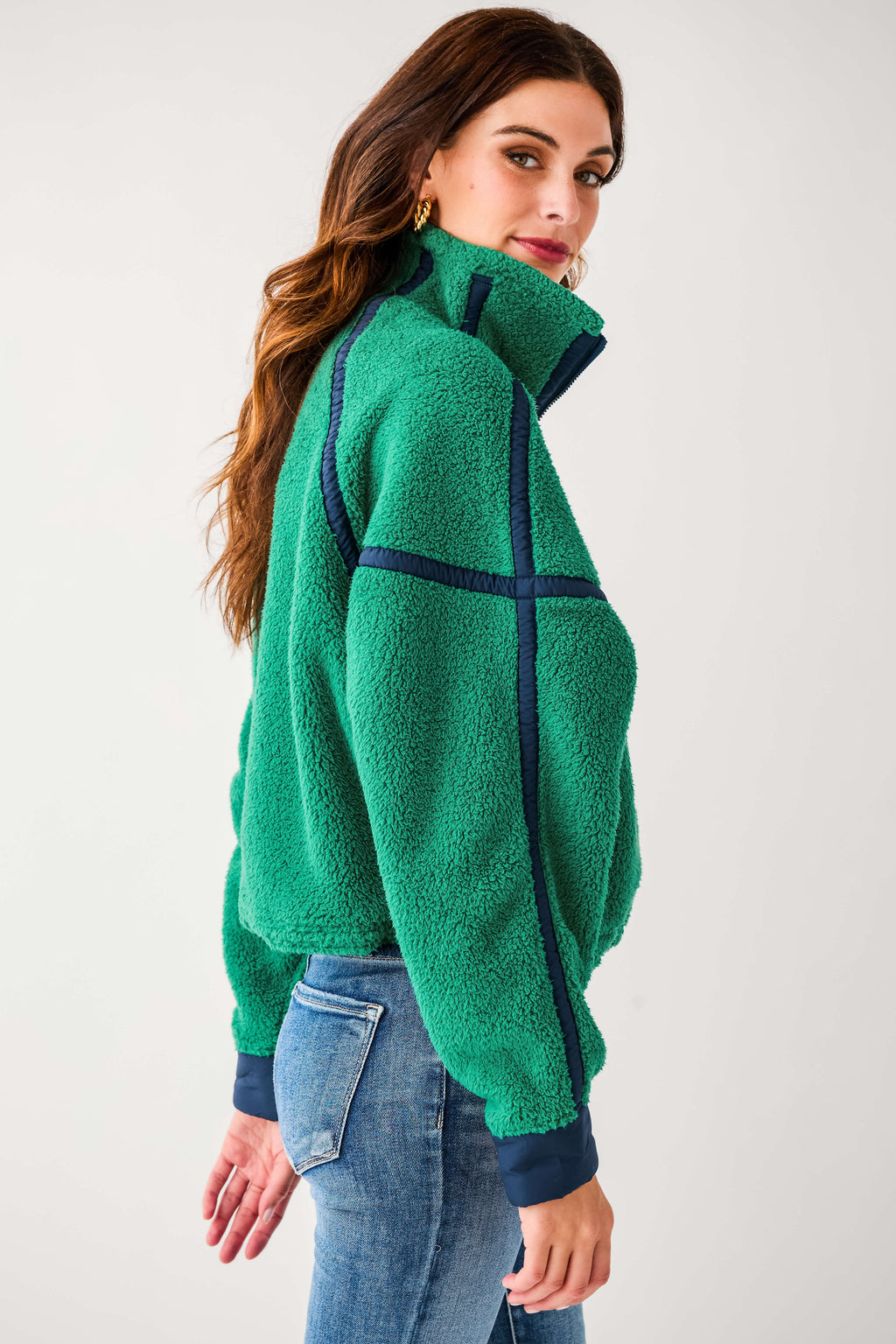 Back view of green 1/2 zip fleece with dark trim bands and cozy texture
