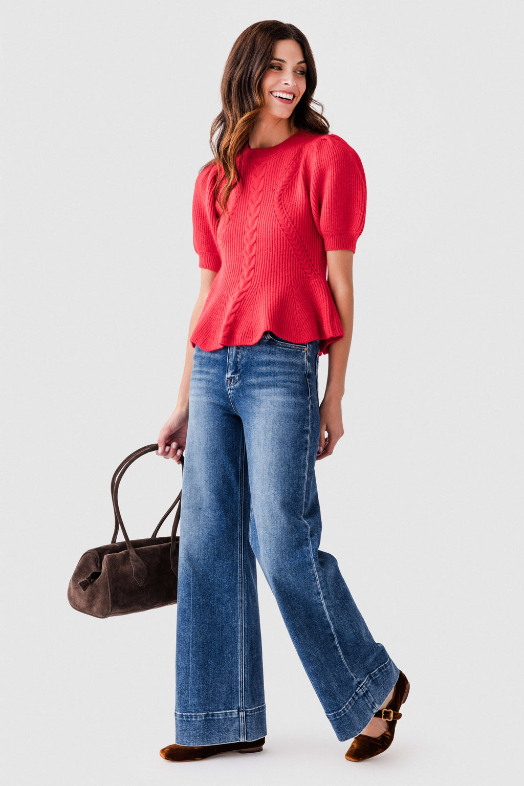 Red knit top with flared puff sleeves and peplum hem, textured cable knit front.