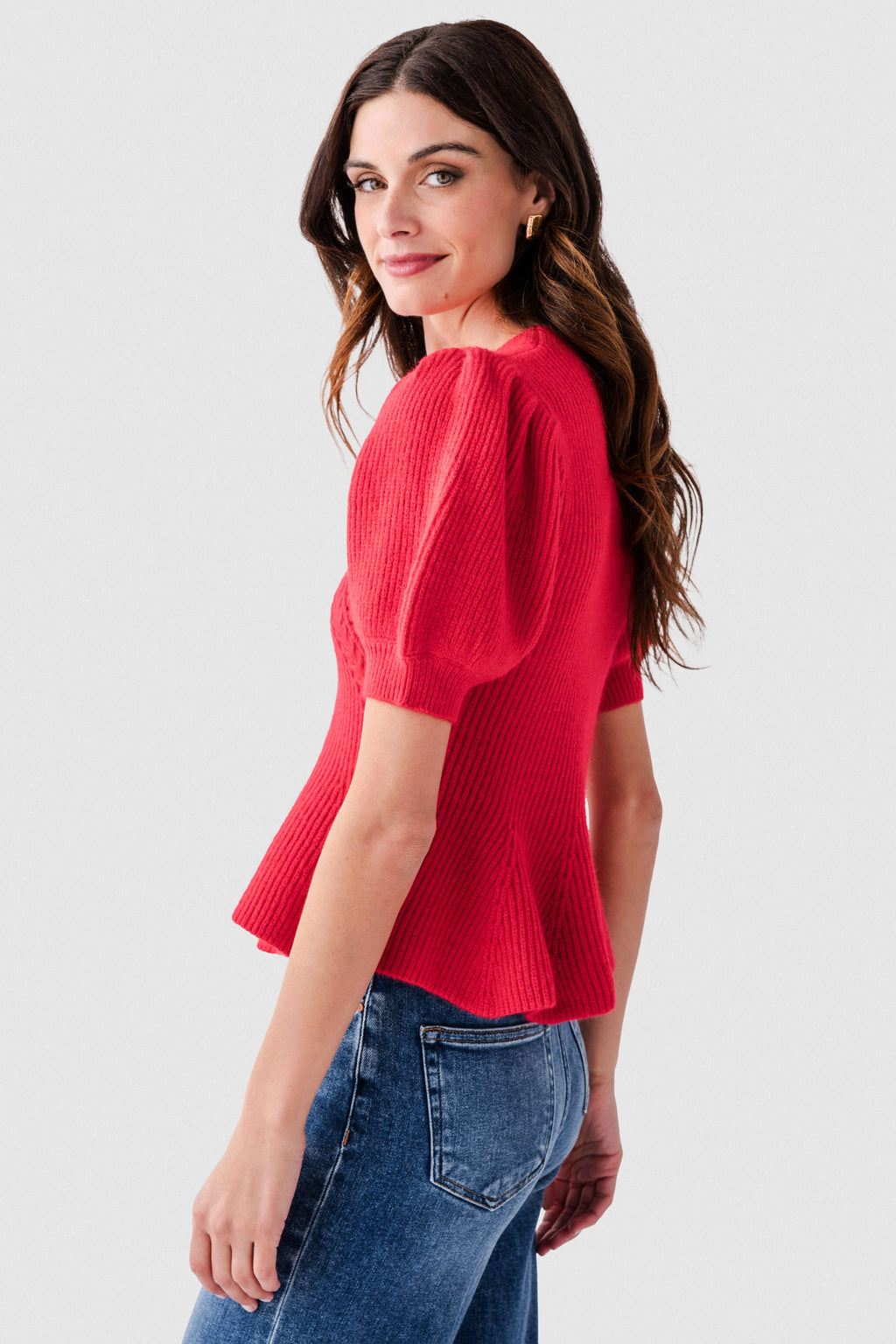Red knit peplum top with short puff sleeves and textured cable detail on front.