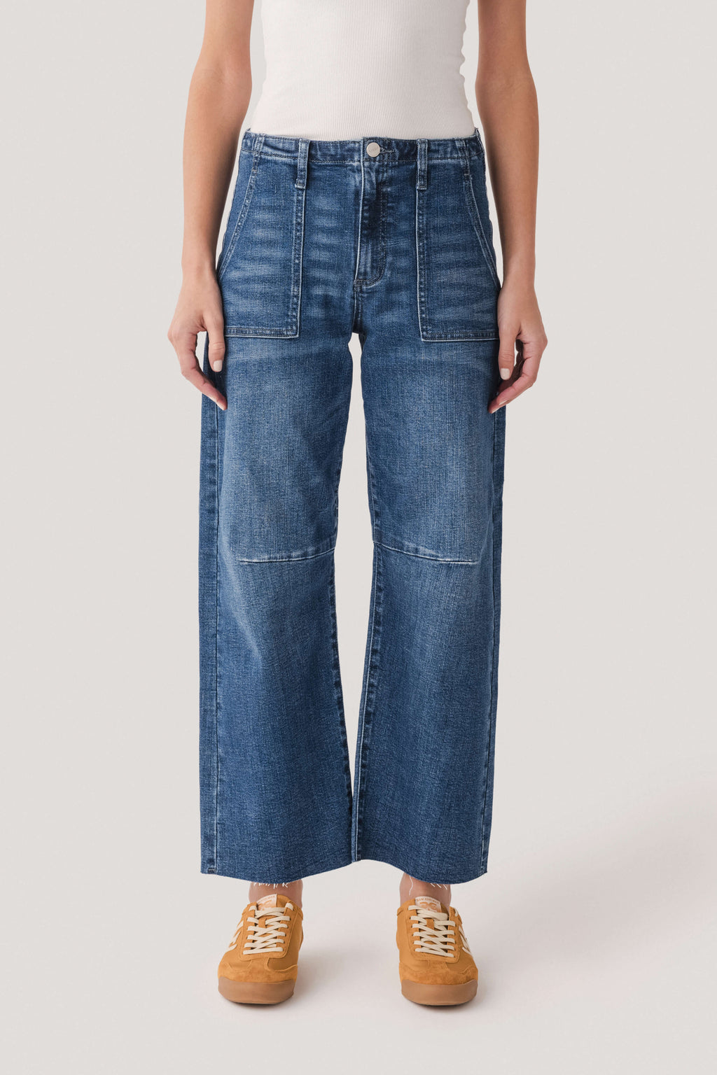 Dark wash barrel jeans front view, button closure and two patch pockets
