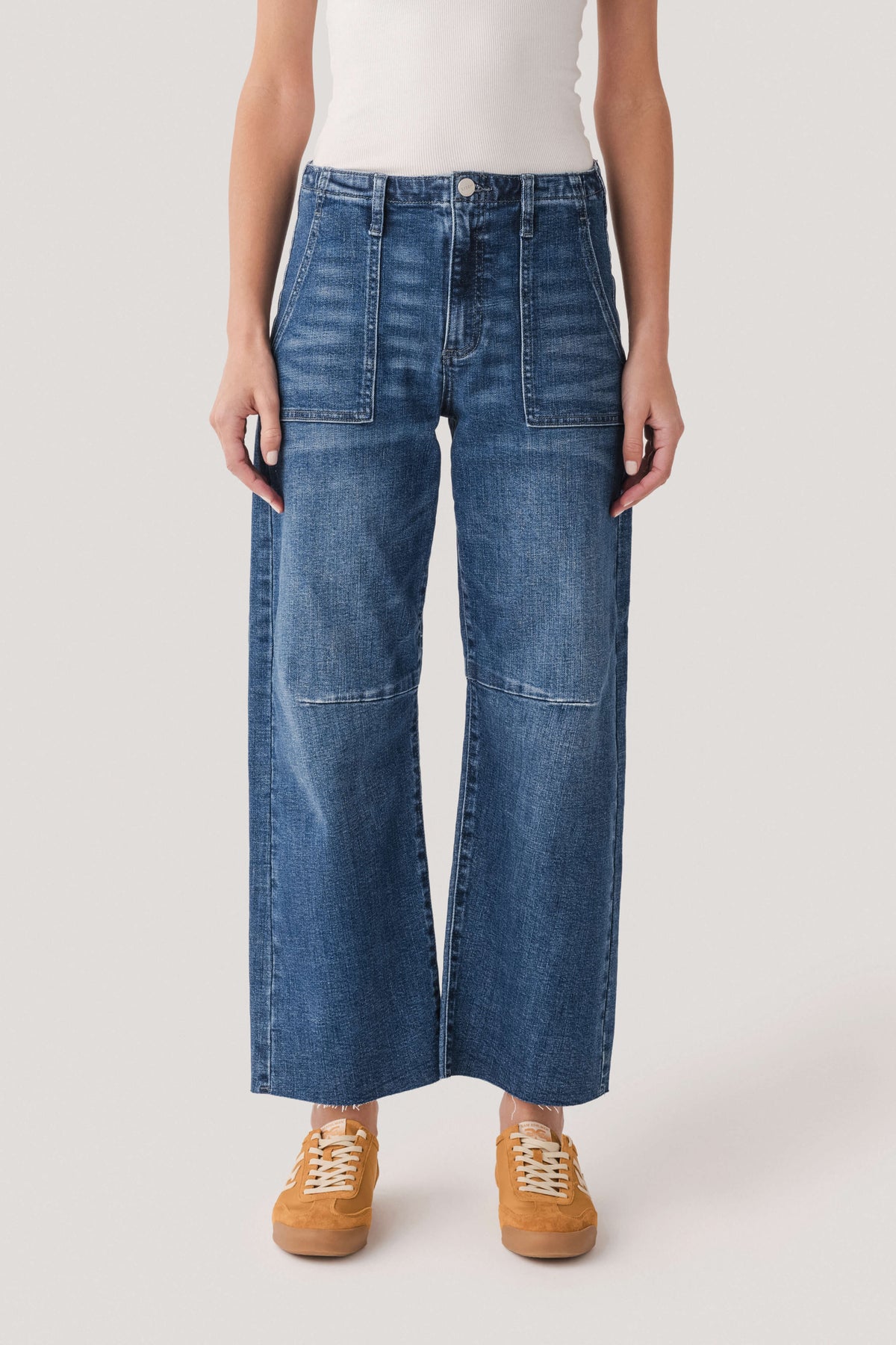 Dark wash barrel jeans front view, button closure and two patch pockets
