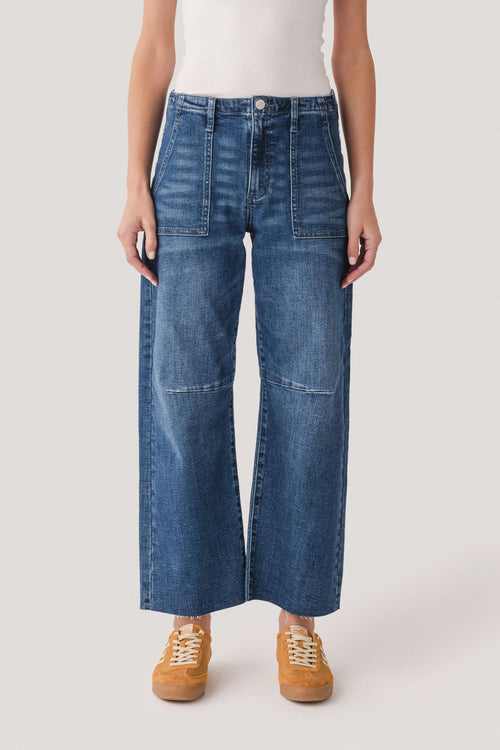 Dark wash barrel jeans front view, button closure and two patch pockets