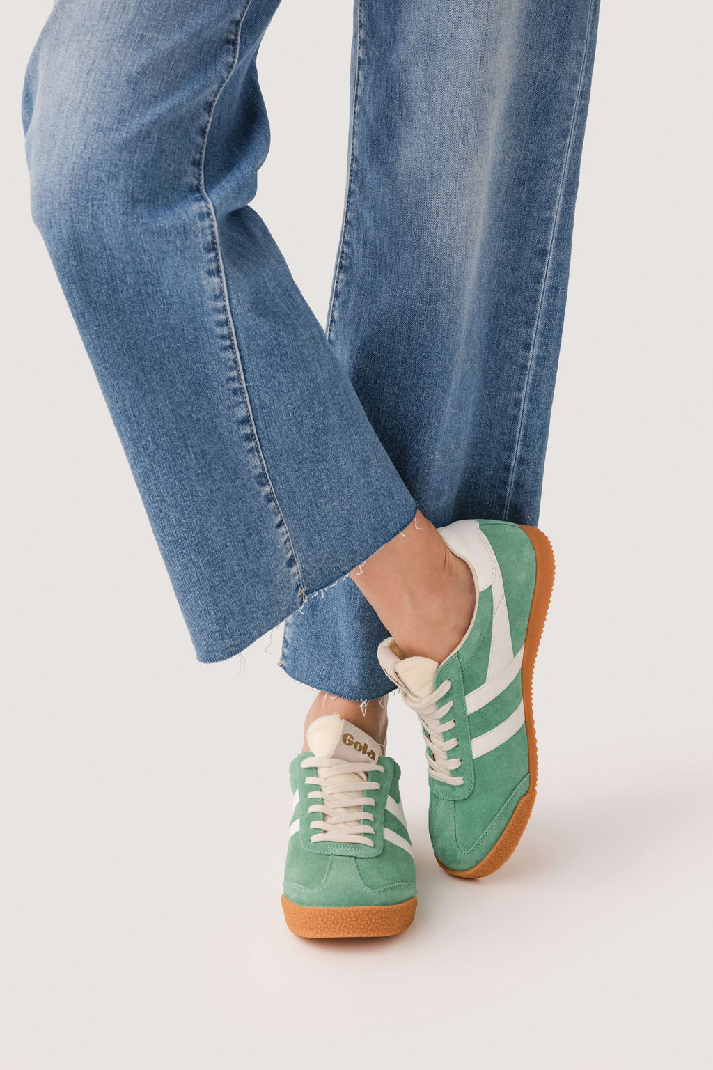 Green and white lace-up sneakers with contrast heel panel and tan gum sole